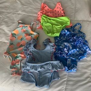 Four 18 month baby girl swim suits, bundled together